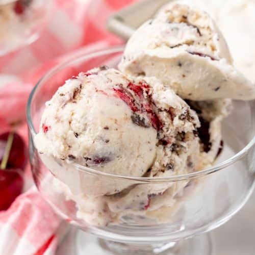 scoops of homemade cherry garcia ice cream in a small glass dish
