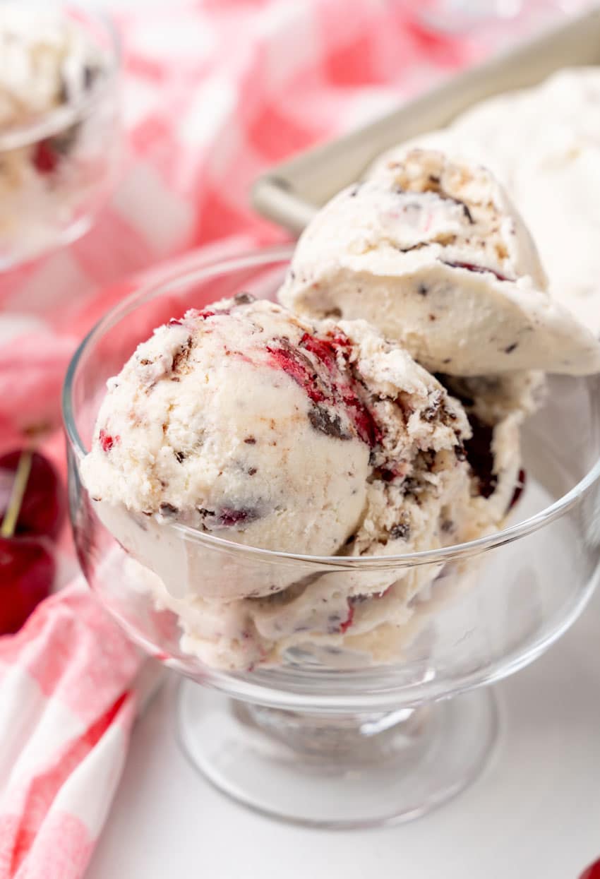 scoops of homemade cherry garcia ice cream in a small glass dish