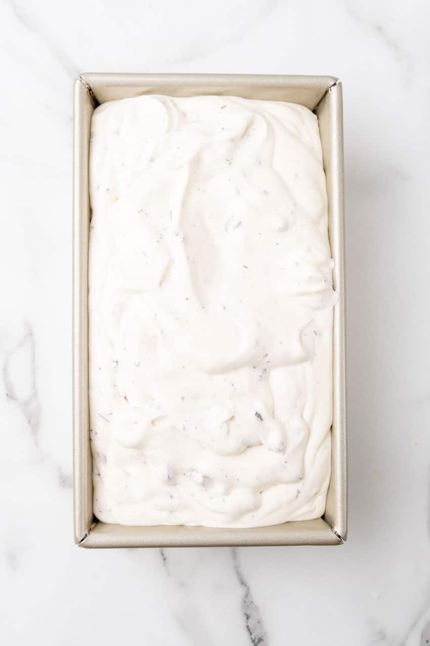no churn cherry chocolate ice cream mixture in a metal loaf pan