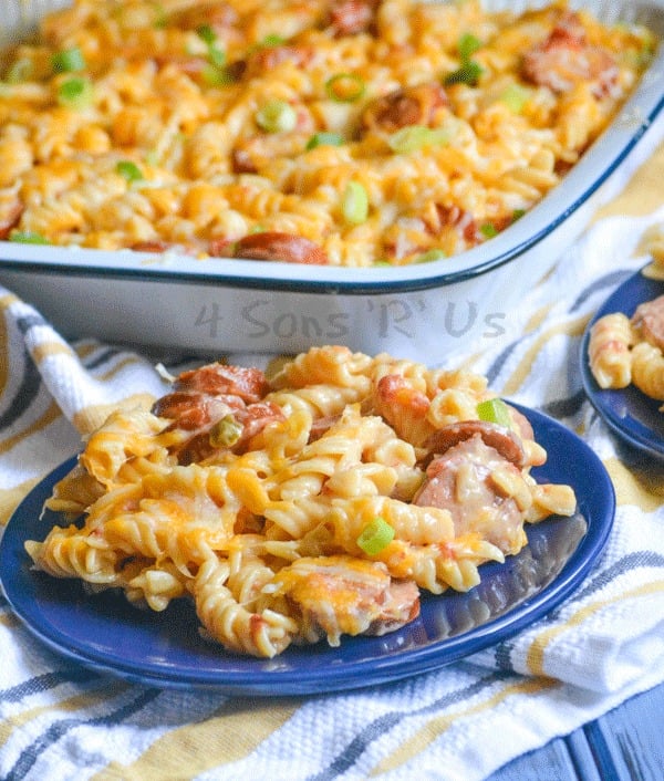 Spicy Sausage and Pasta Casserole served on a blue plate with the casserole in the background