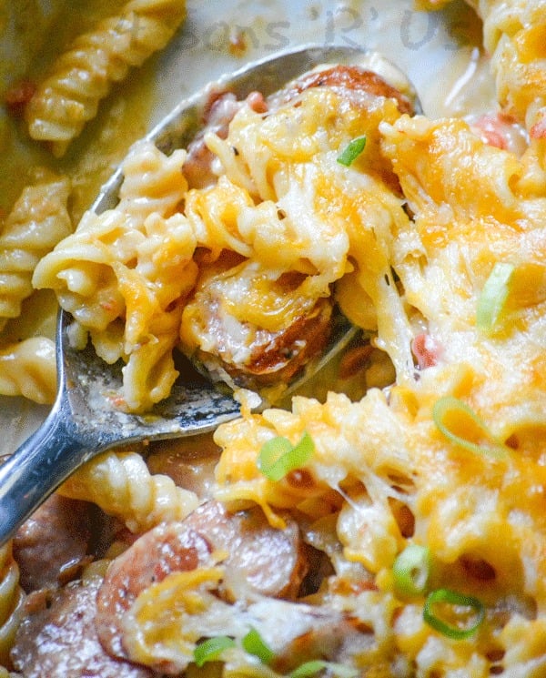 a silver spoon is shown with a scoop of Spicy Sausage and Pasta Casserole