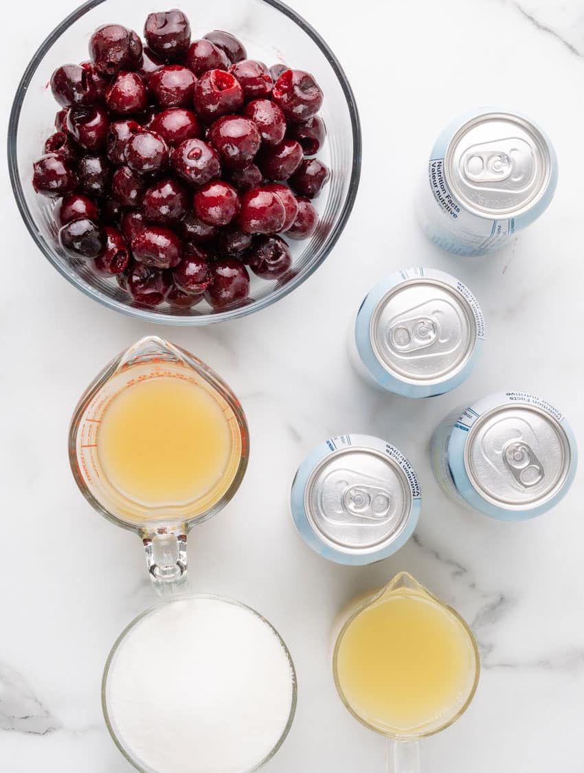 an overhead image showing the measured ingredients needed to make a batch of homemade black cherry limeade