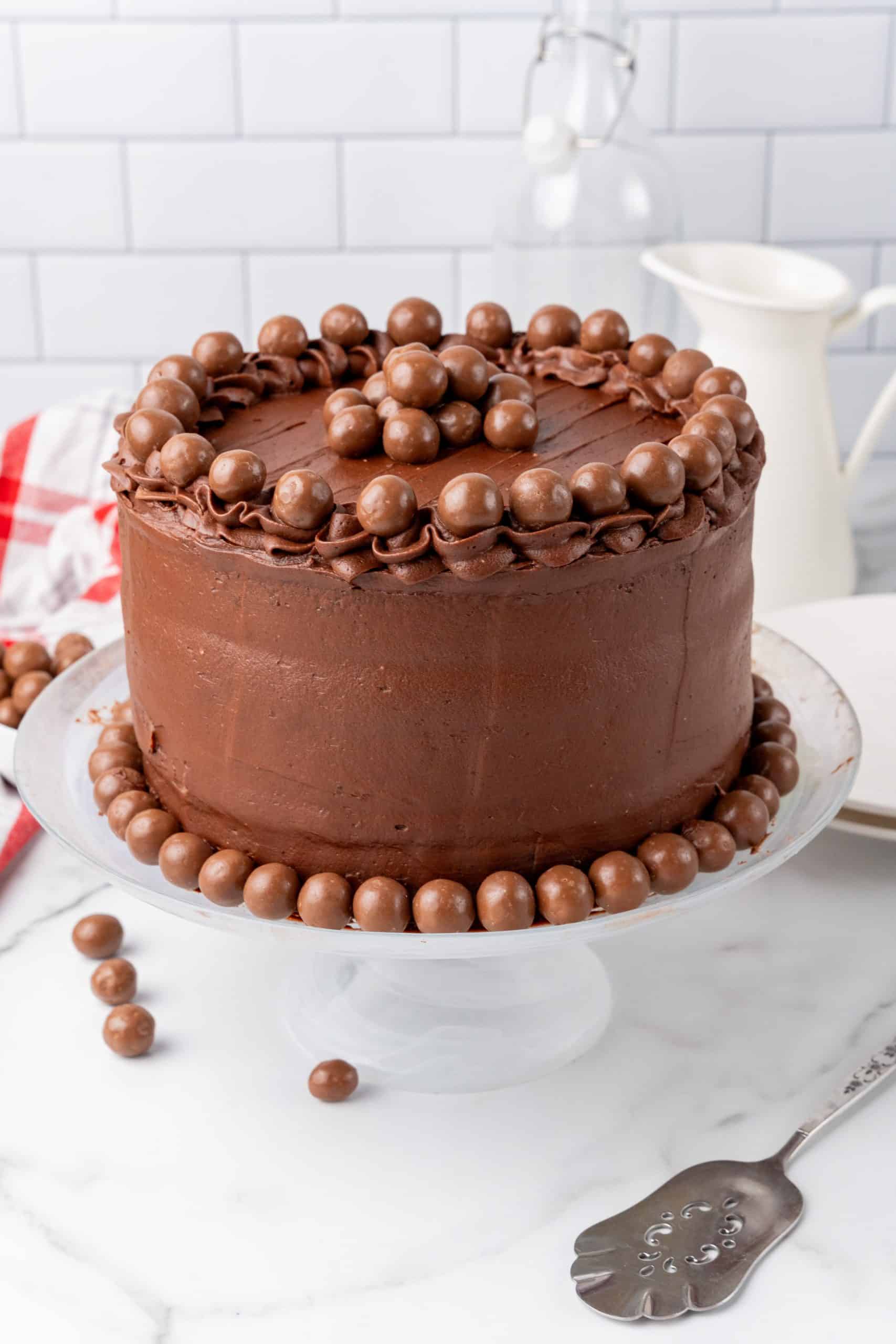 chocolate malted cake recipe on a white cake stand