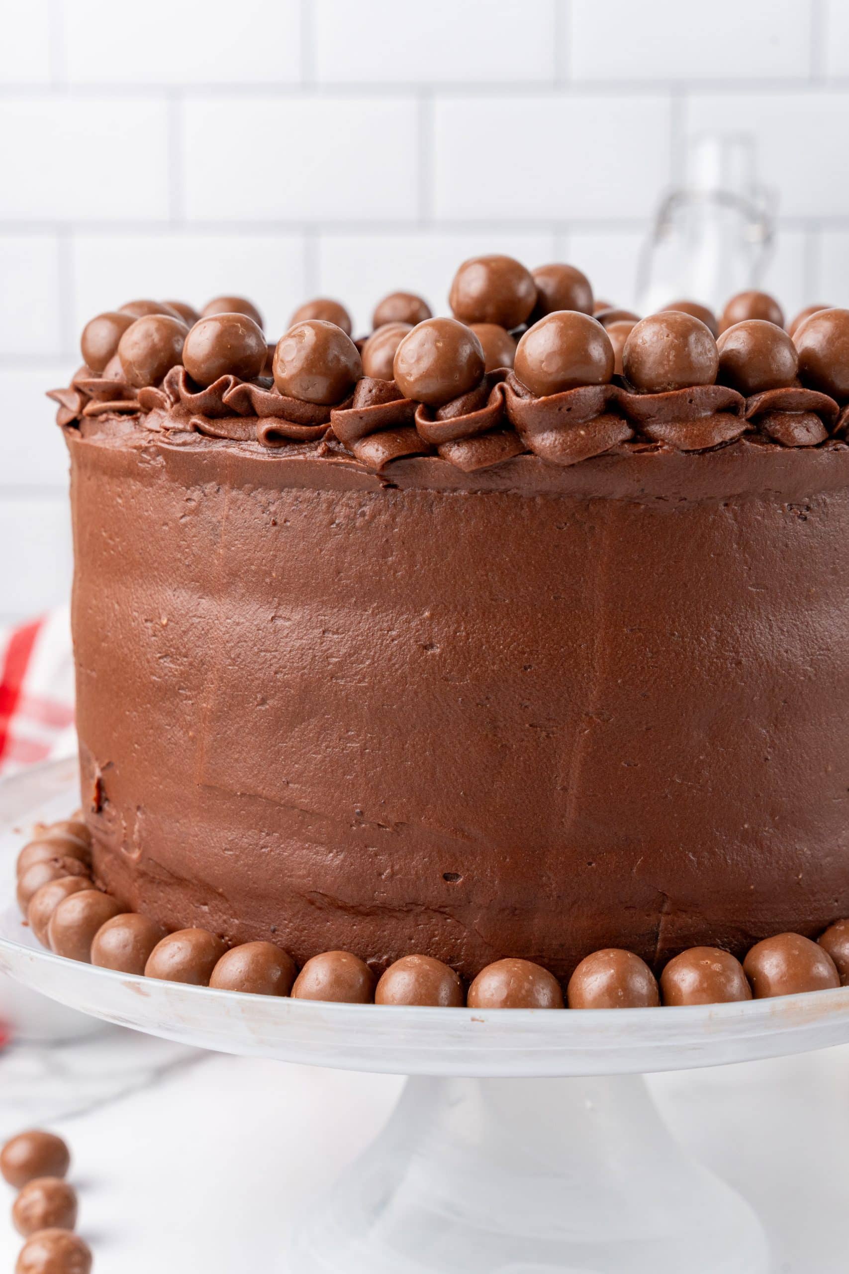 chocolate malted cake recipe on a white cake stand