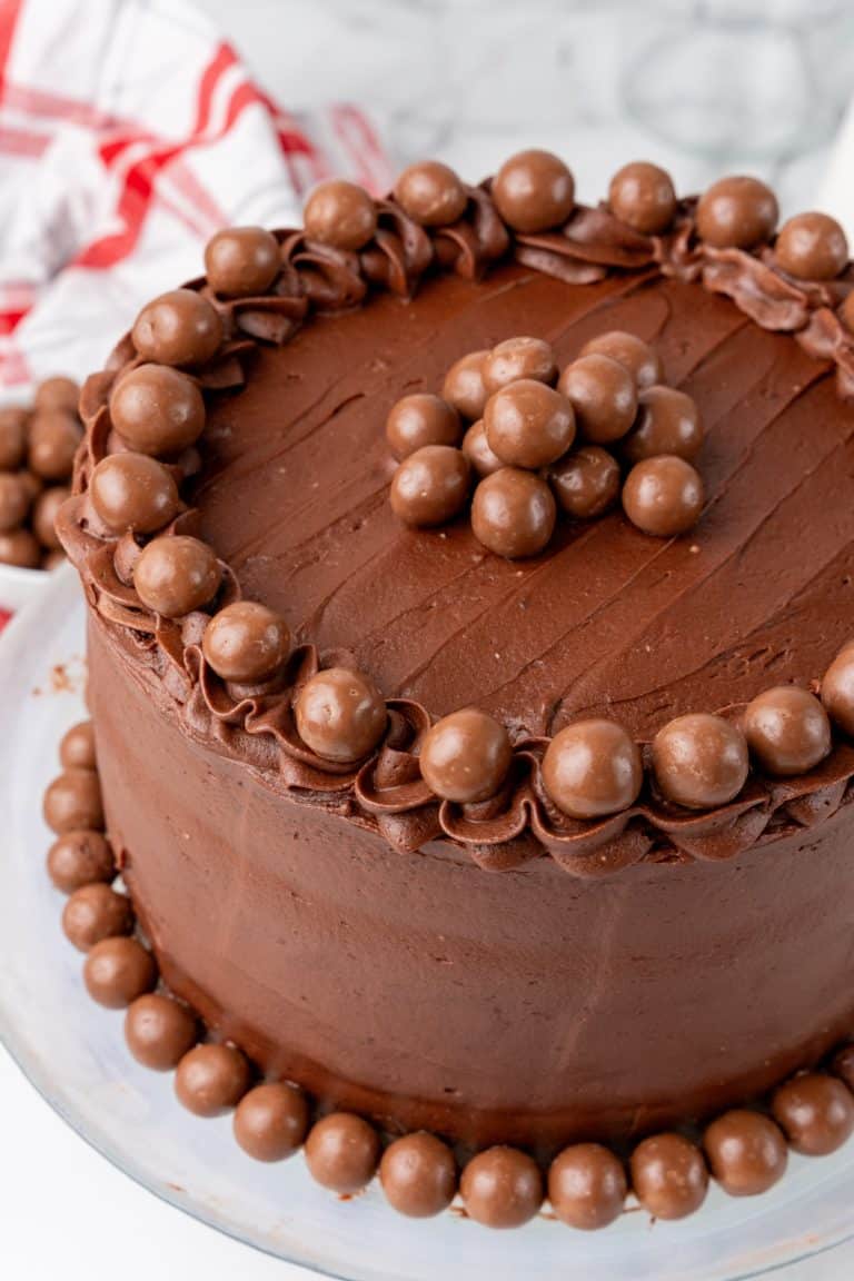 chocolate malted cake recipe on a white cake stand