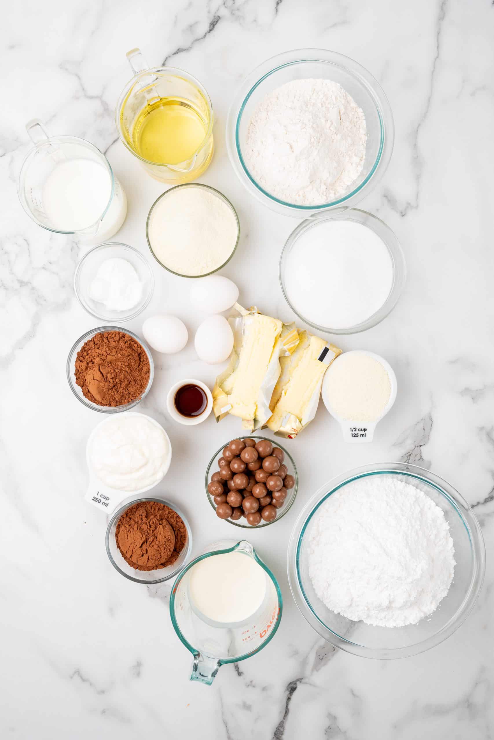 an overhead image showing the measured ingredients needed to make a chocolate malted cake recipe