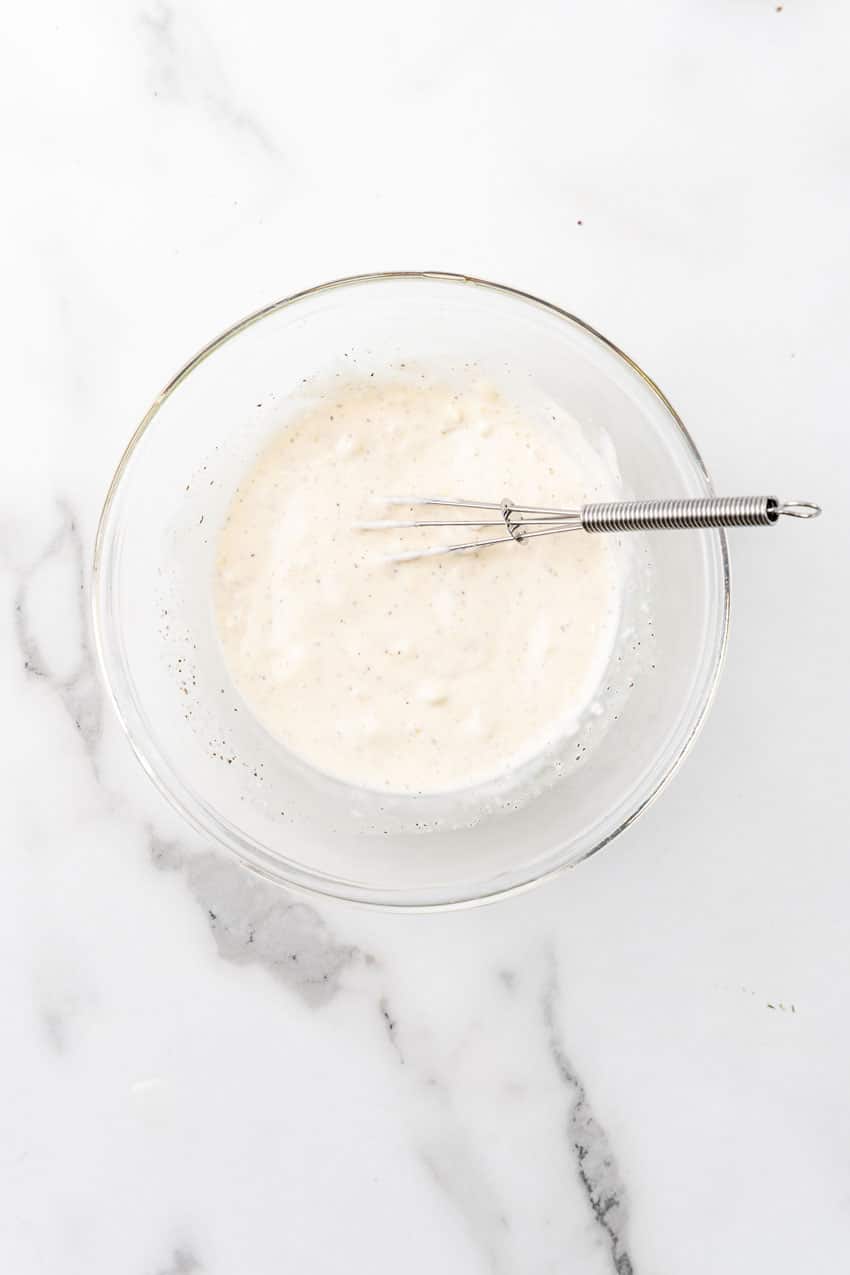 homemade garlic aioli in a glass mixing bowl