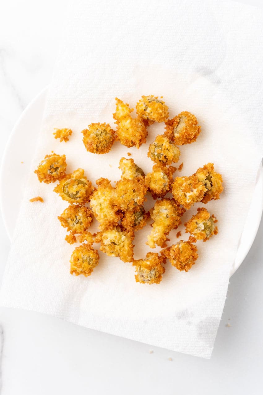 fried olives on a paper towel lined plate