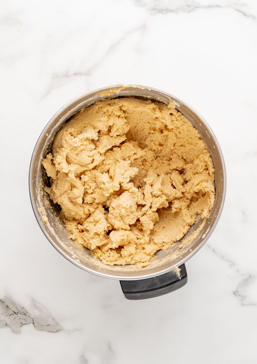 chocolate chip cookie batter in a metal mixing bowl