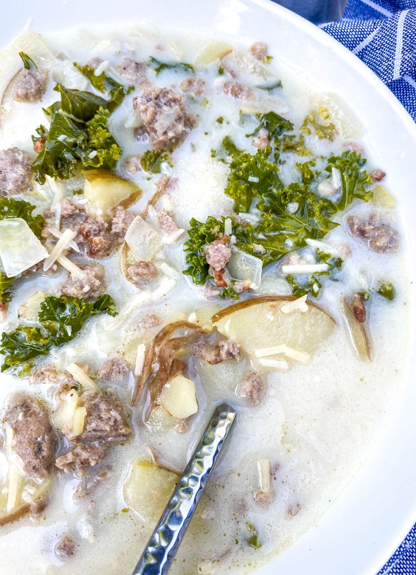 a shallow white bowl filled with slow cooker zuppa toscana
