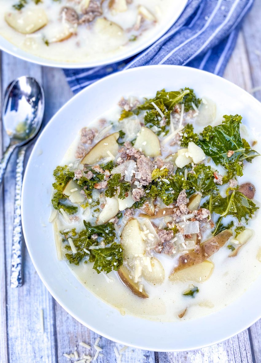 a shallow white bowl filled with slow cooker zuppa toscana