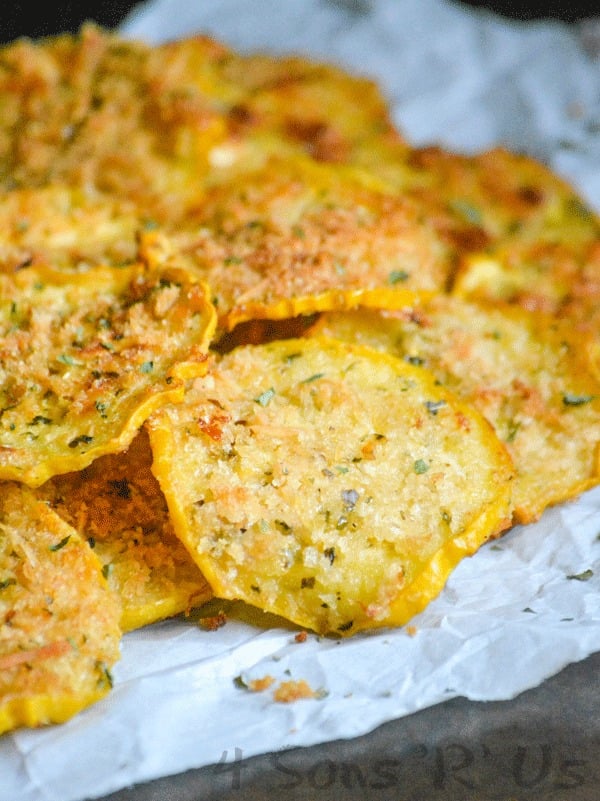 Crispy Garlic Parmesan Squash Chips piled on white parchment paper