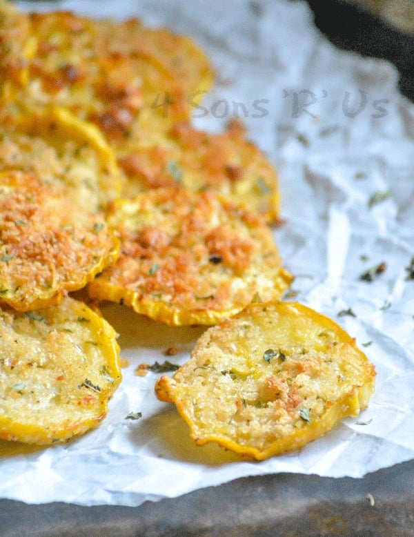 Crispy Garlic Parmesan Squash Chips piled on white parchment paper