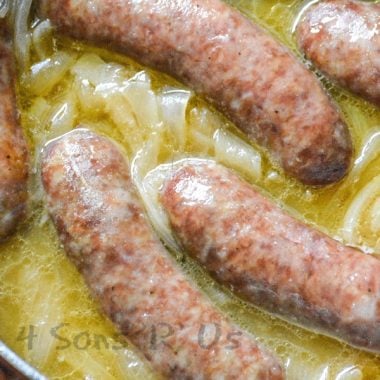 smoked beer brats with caramelized onions in a skillet