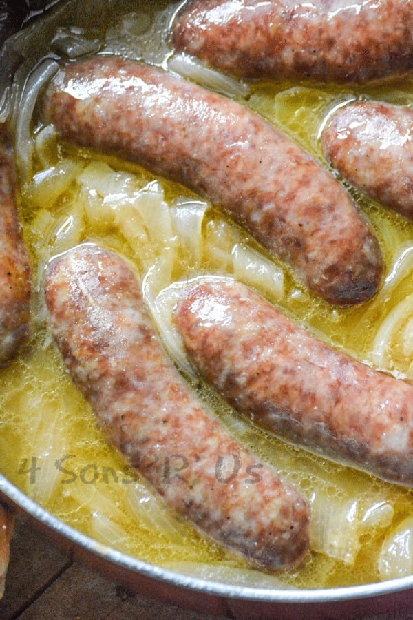 smoked beer brats with caramelized onions in a skillet