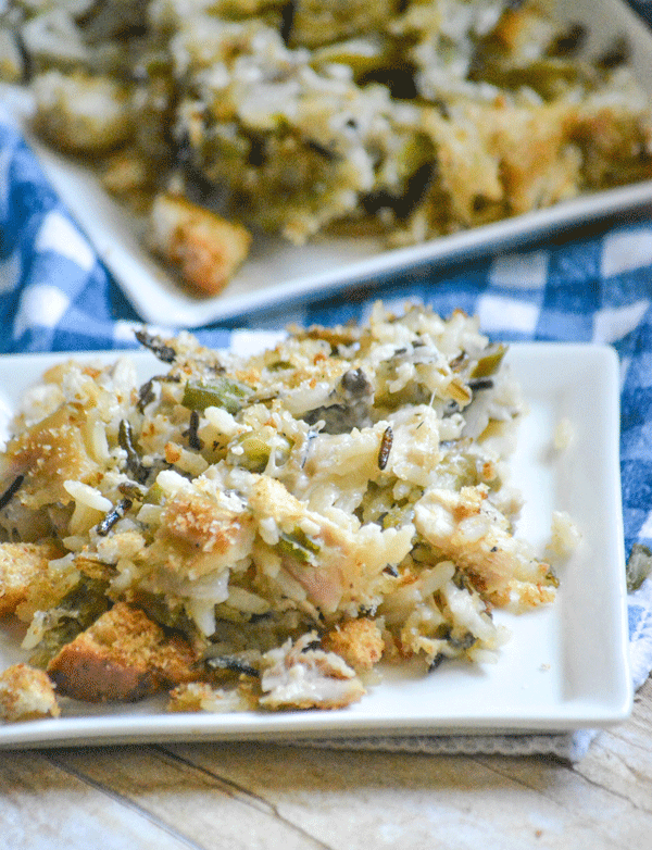 creamy chicken caesar and wild rice casserole served on white plates