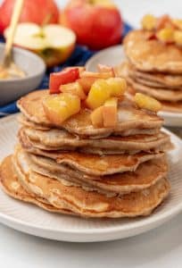stacks of homemade apple pie pancakes on small white plates
