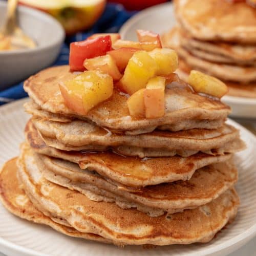 stacks of homemade apple pie pancakes on small white plates