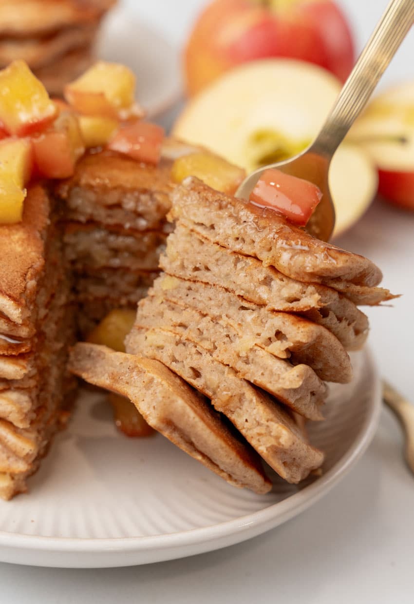 a silver fork holding up slices of homemade apple pie pancakes