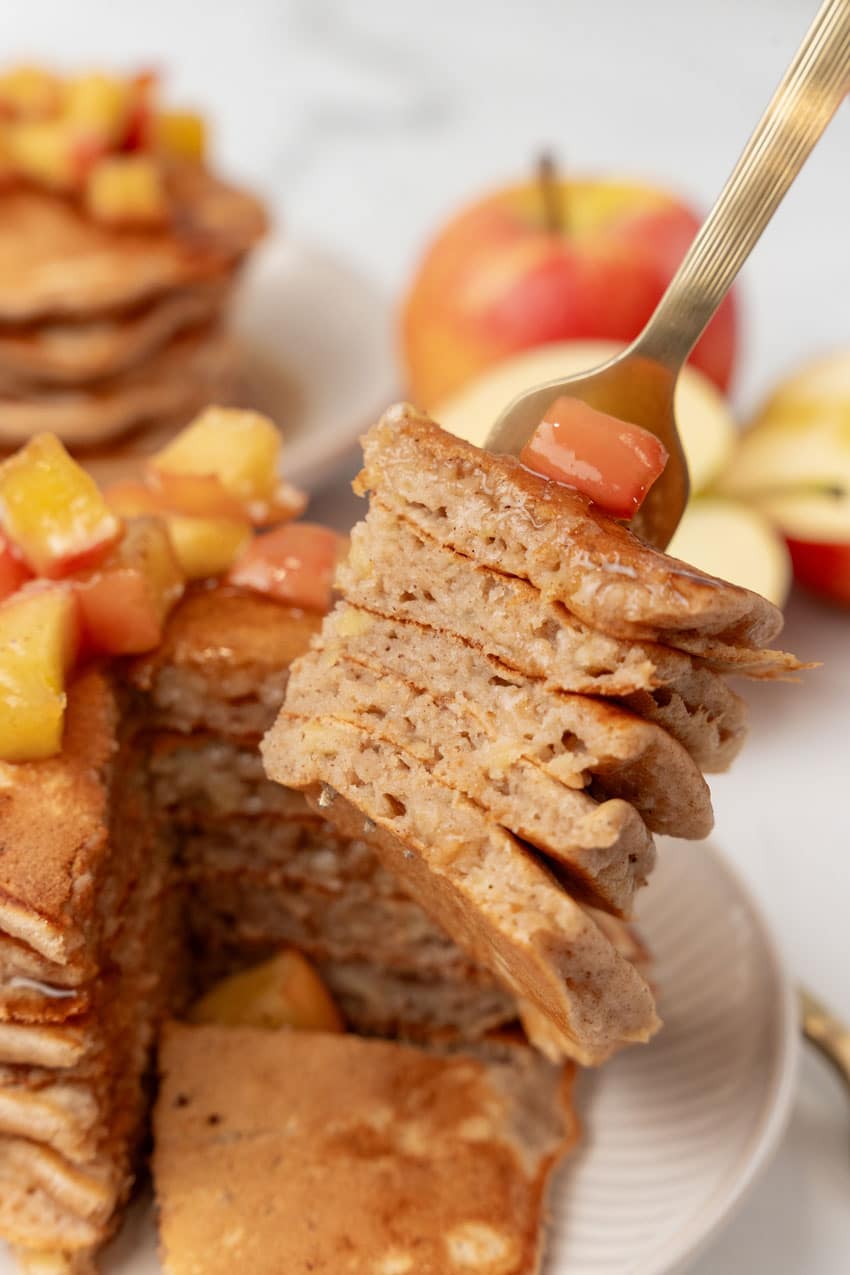 a silver fork holding up slices of homemade apple pie pancakes