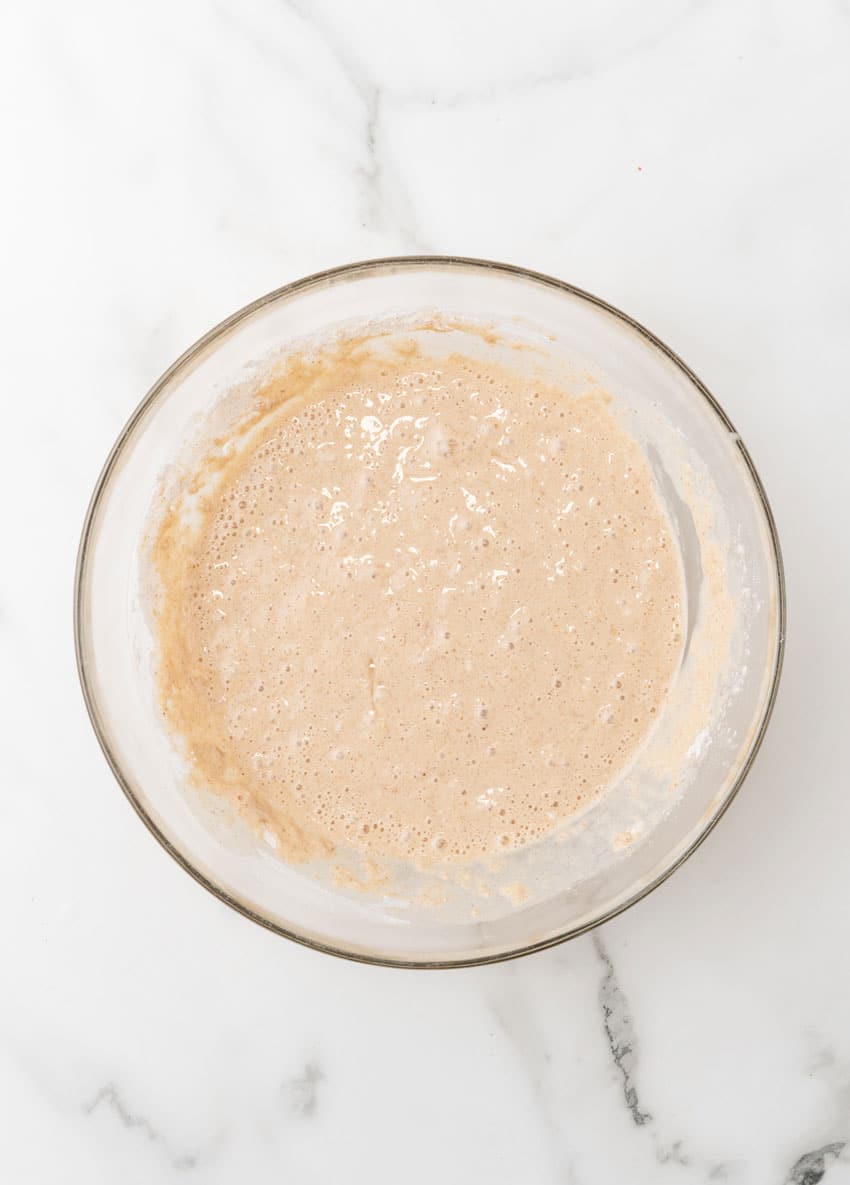apple pie pancake batter in a glass mixing bowl