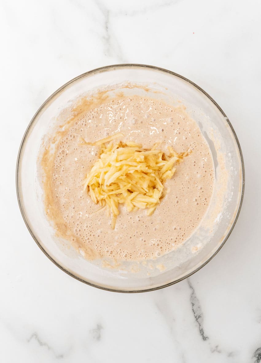 apple pie pancake batter in a glass mixing bowl