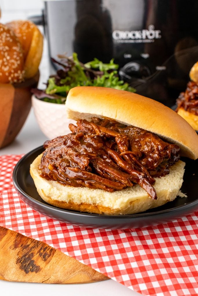 crockpot beef brisket sandwich with a toothpick stuck in the middle
