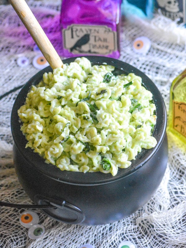 halloween themed macaroni and cheese in a black plastic cauldron