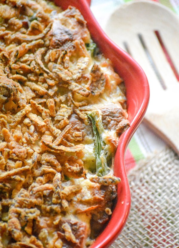 GREEN BEAN CASSEROLE BREAD PUDDING IN A RED CASSEROLE DISH WITH SCALLOPED EDGES