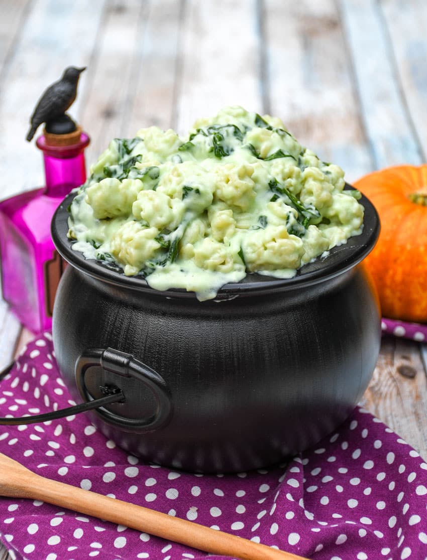 witch Halloween mac and cheese in a black plastic cauldron