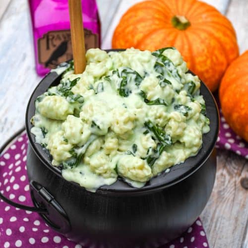 witch Halloween mac and cheese in a black plastic cauldron