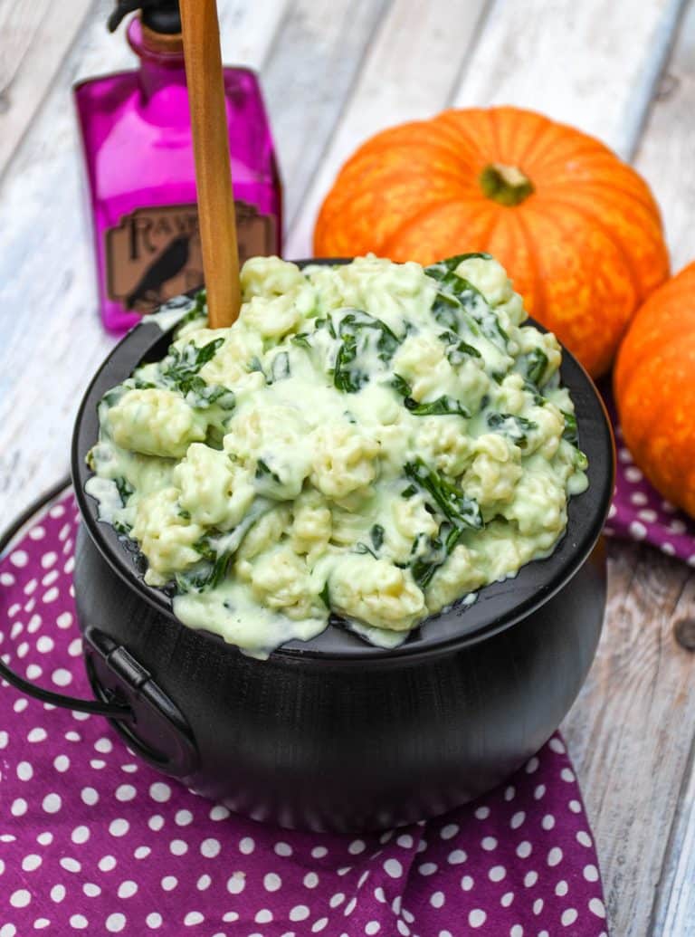 witch Halloween mac and cheese in a black plastic cauldron