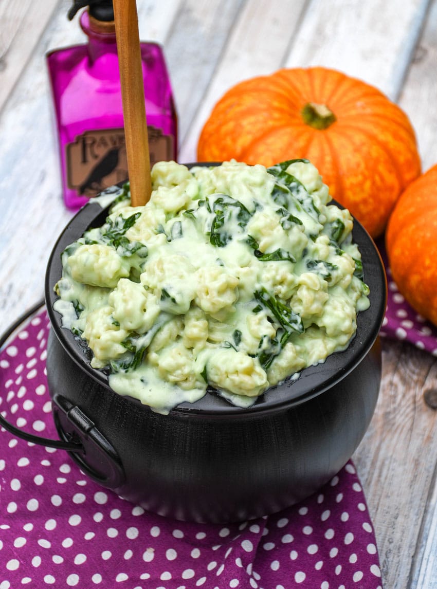 witch Halloween mac and cheese in a black plastic cauldron