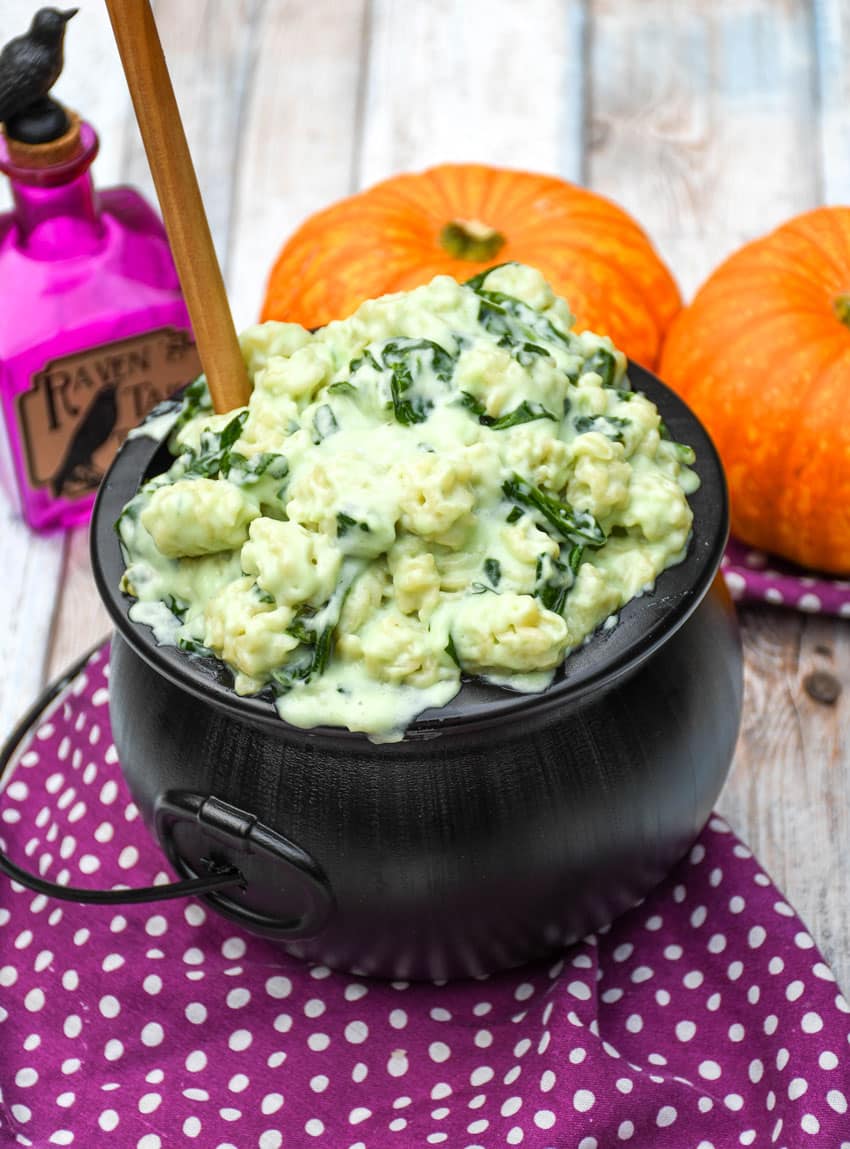 witch Halloween mac and cheese in a black plastic cauldron