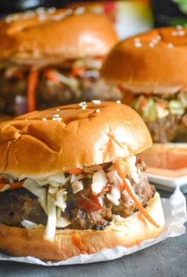 mongolian barbecue burgers with asian slaw on sheets or parchment paper