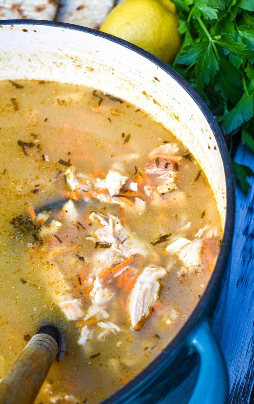 greek lemon chicken soup in a large blue dutch oven