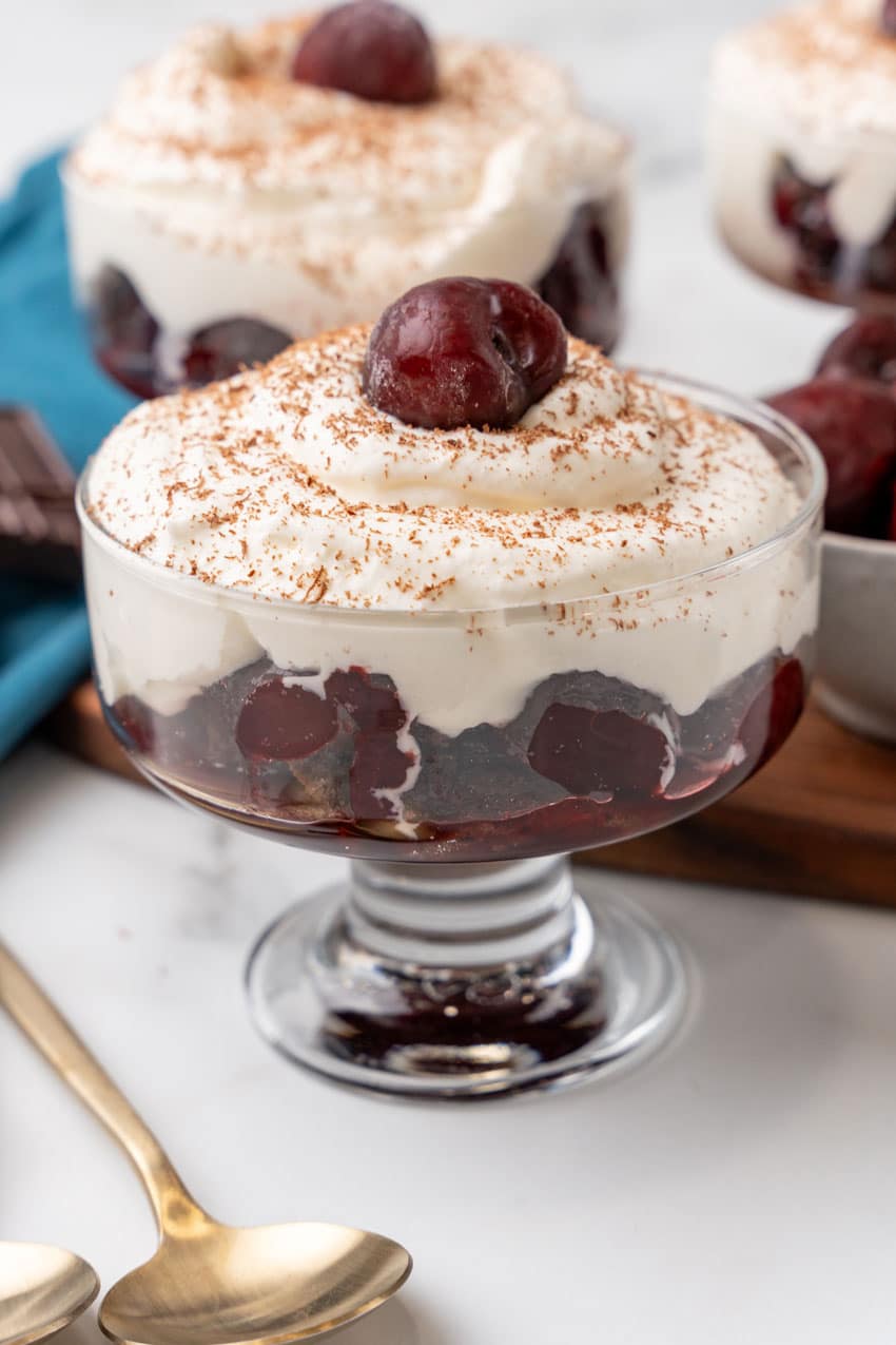 black forest cherry cheesecake cups on a marble countertop