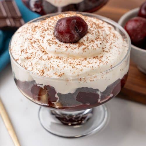 black forest cherry cheesecake cups on a marble countertop