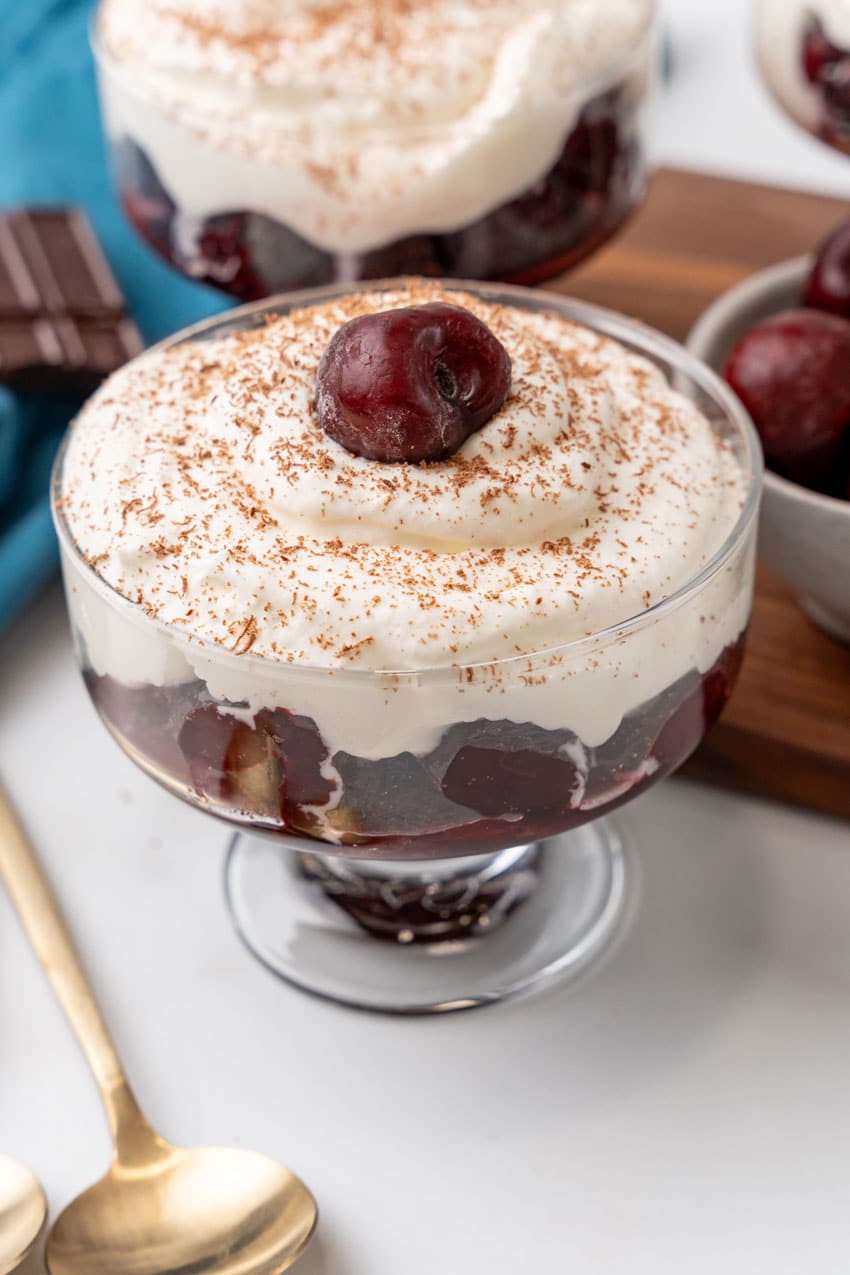 black forest cherry cheesecake cups on a marble countertop