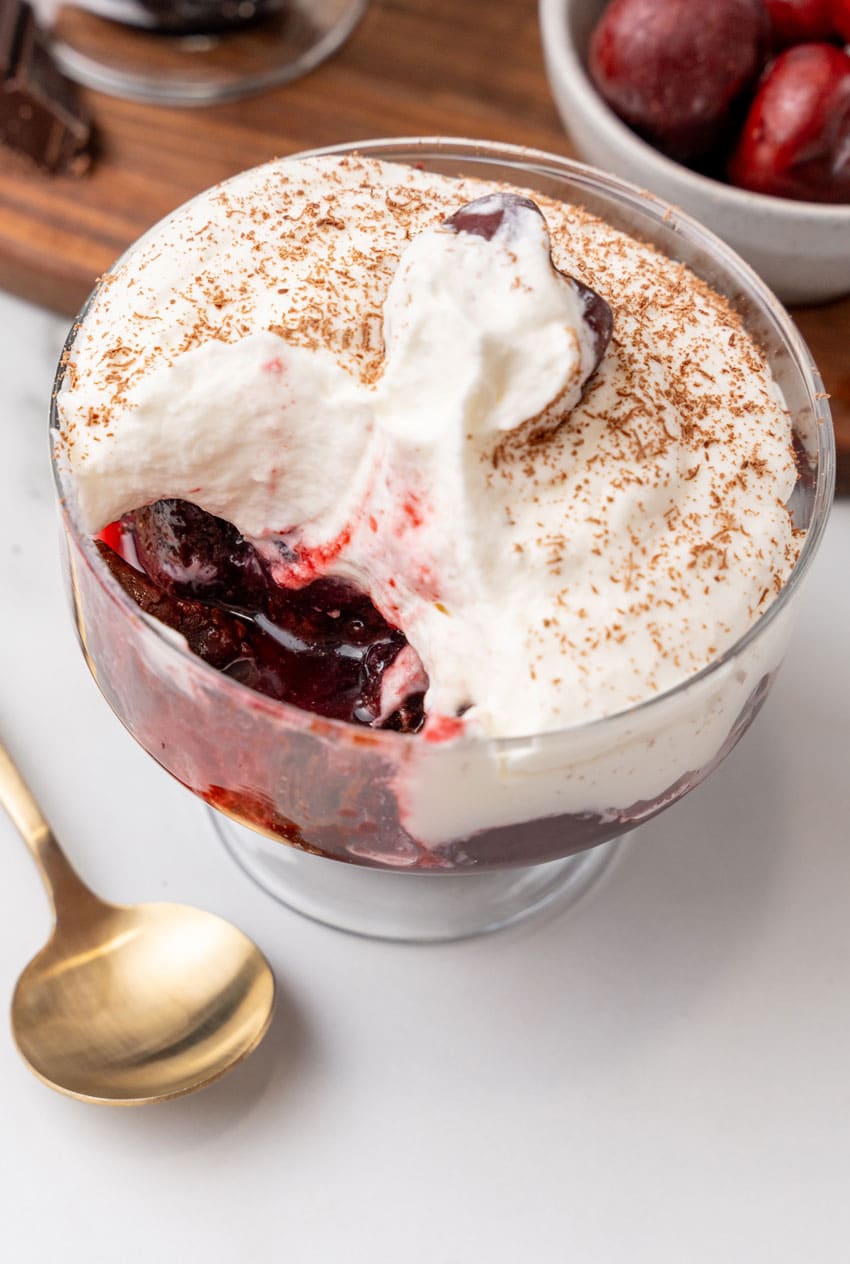 black forest cherry cheesecake cups on a marble countertop