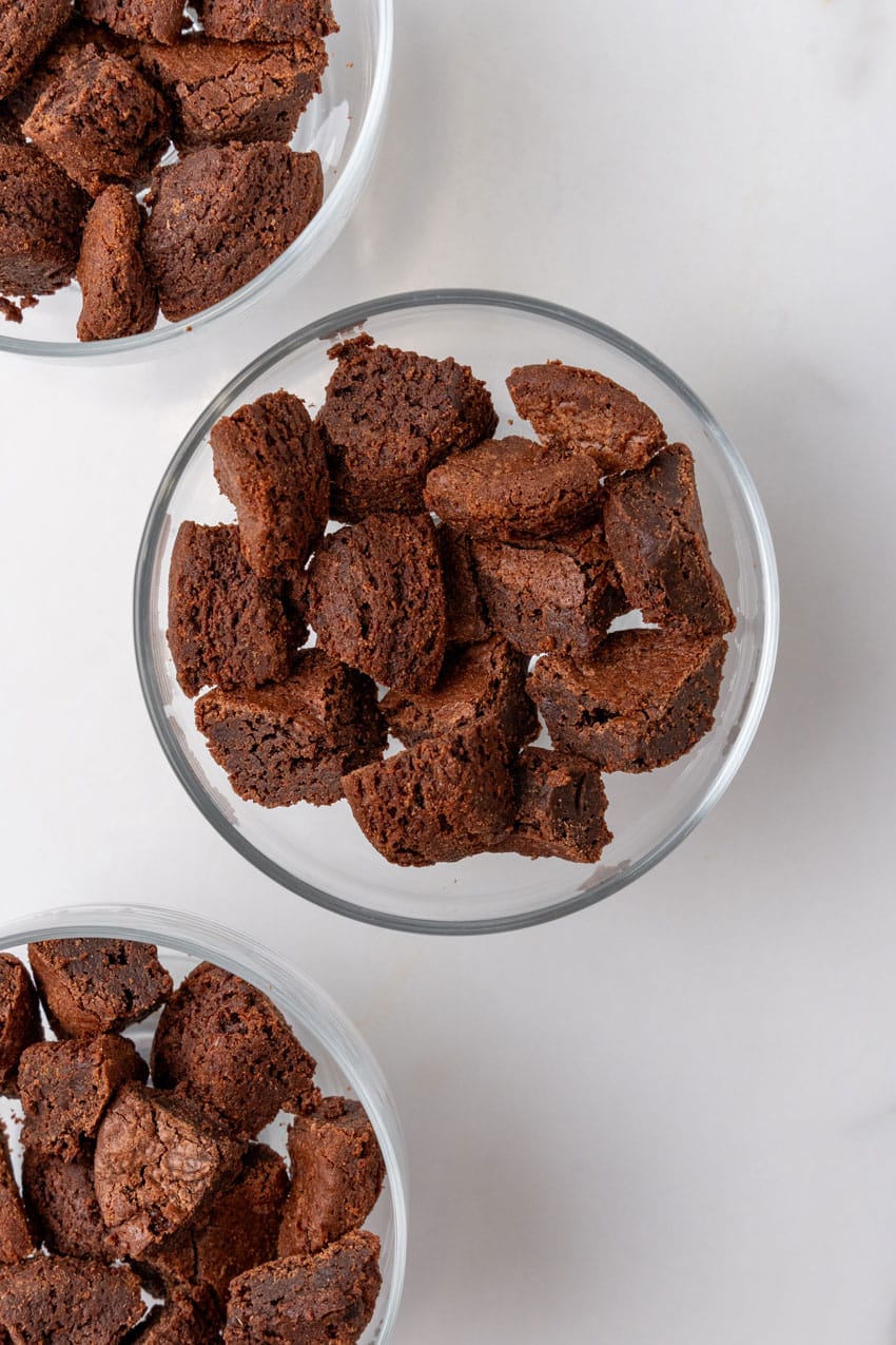 chopped up brownies in the bottom of a small glass bowl