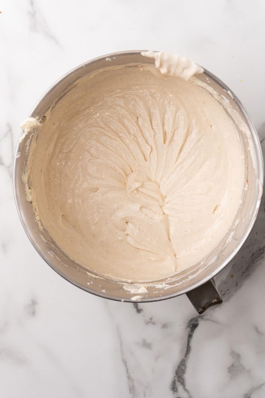 eggnog cheesecake batter in the metal bowl of a stand mixer