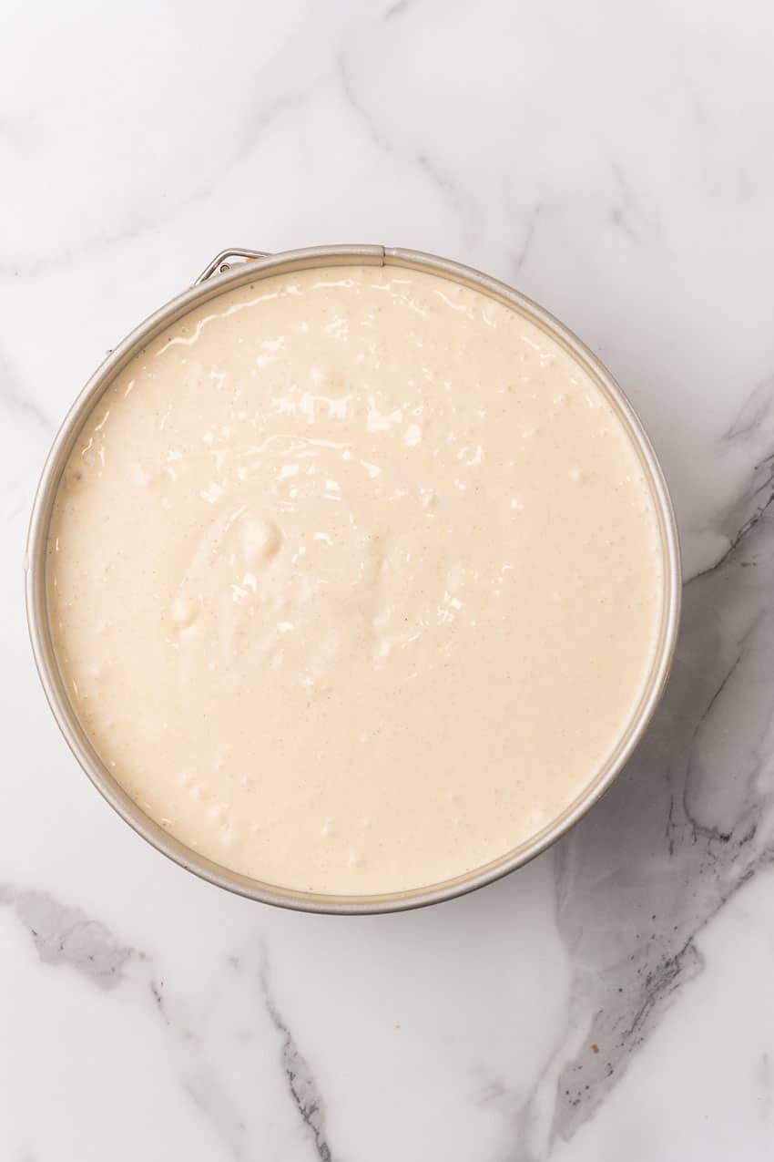 eggnog cheesecake batter in a metal springform pan