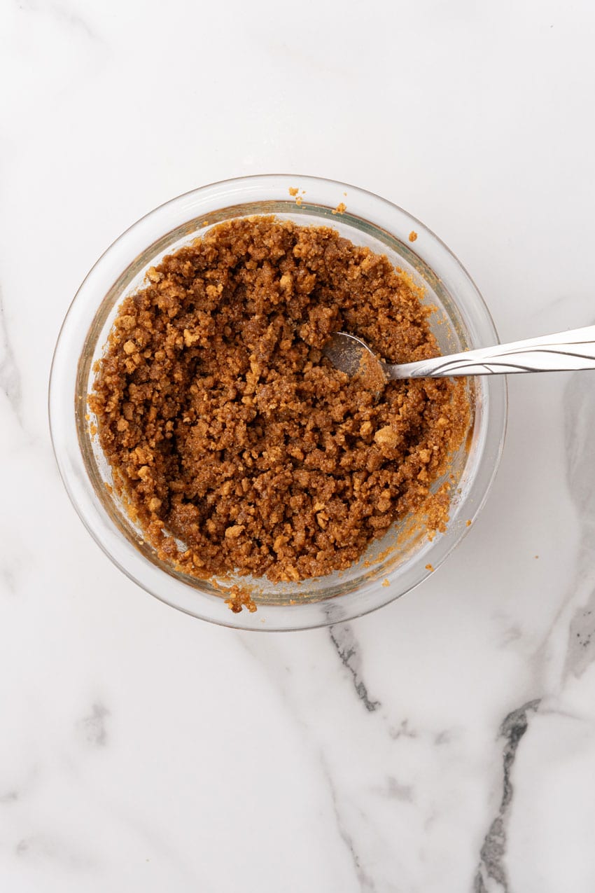 buttered sweetened graham cracker crumbs in a glass mixing bowl