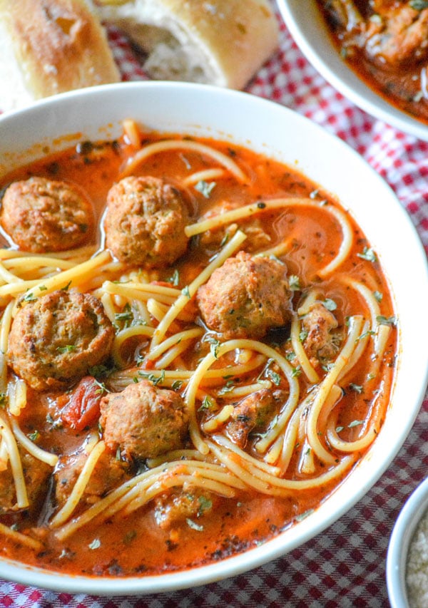 slow cooker spaghetti and meatball soup in a white bowl