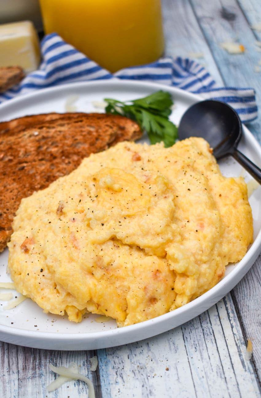 three cheese grits casserole on a white plate