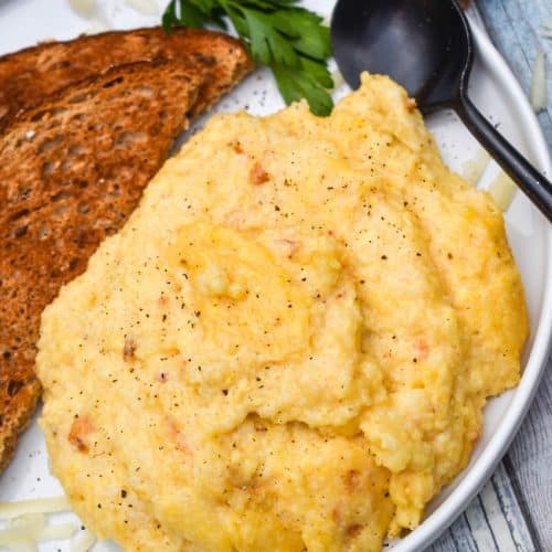 three cheese grits casserole on a white plate