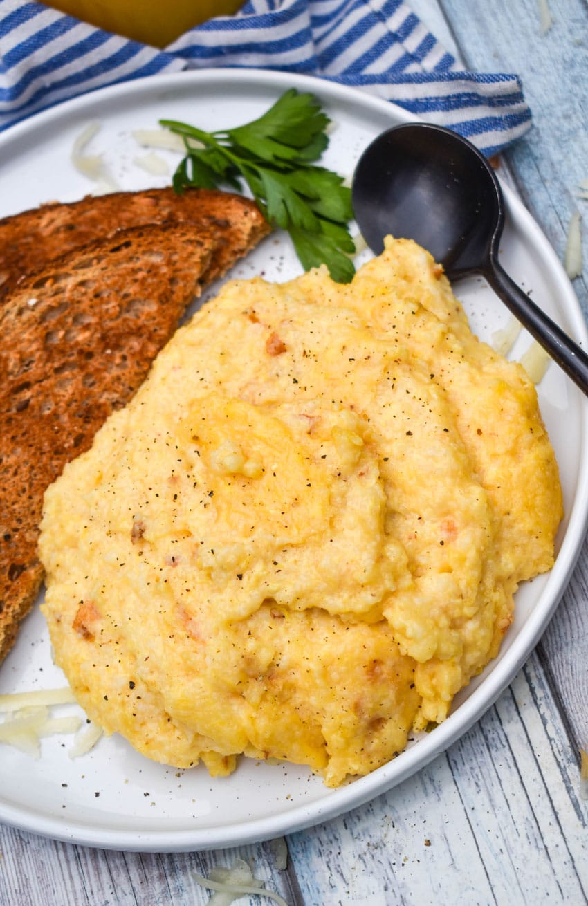 three cheese grits casserole on a white plate