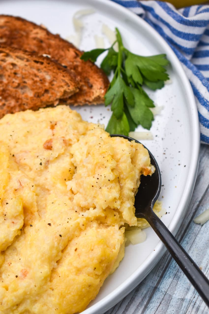 three cheese grits casserole on a white plate