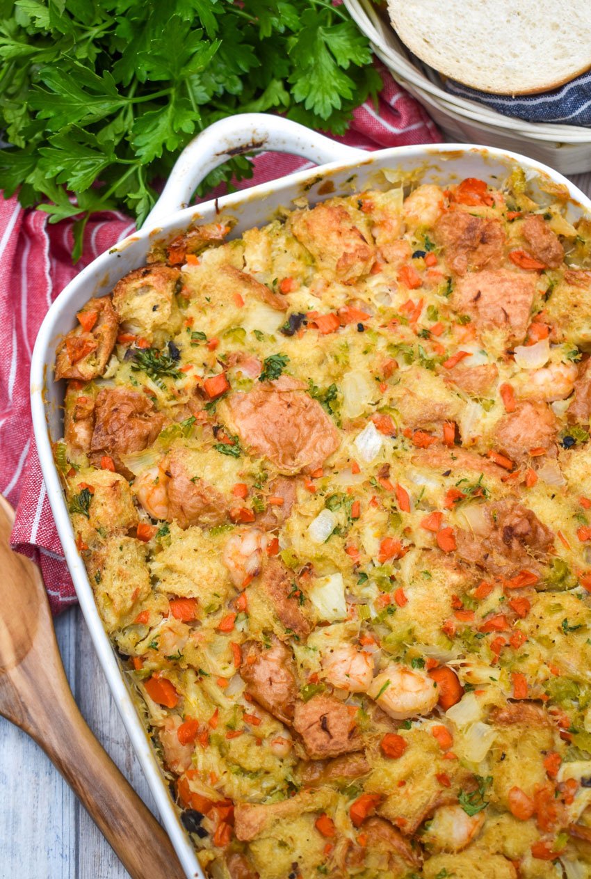 baked seafood stuffing in a white casserole dish